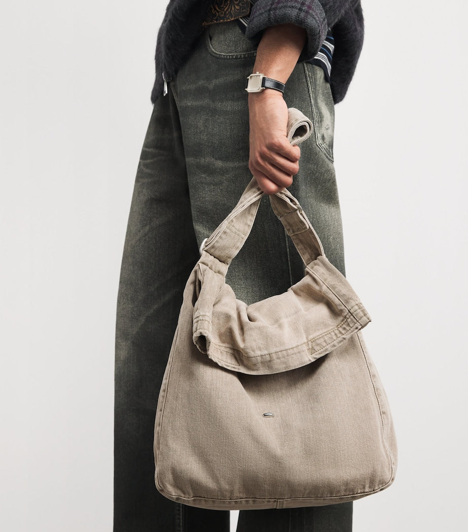 Our Legacy denim sling shoulder bag with mineral pigment, imported from the UK