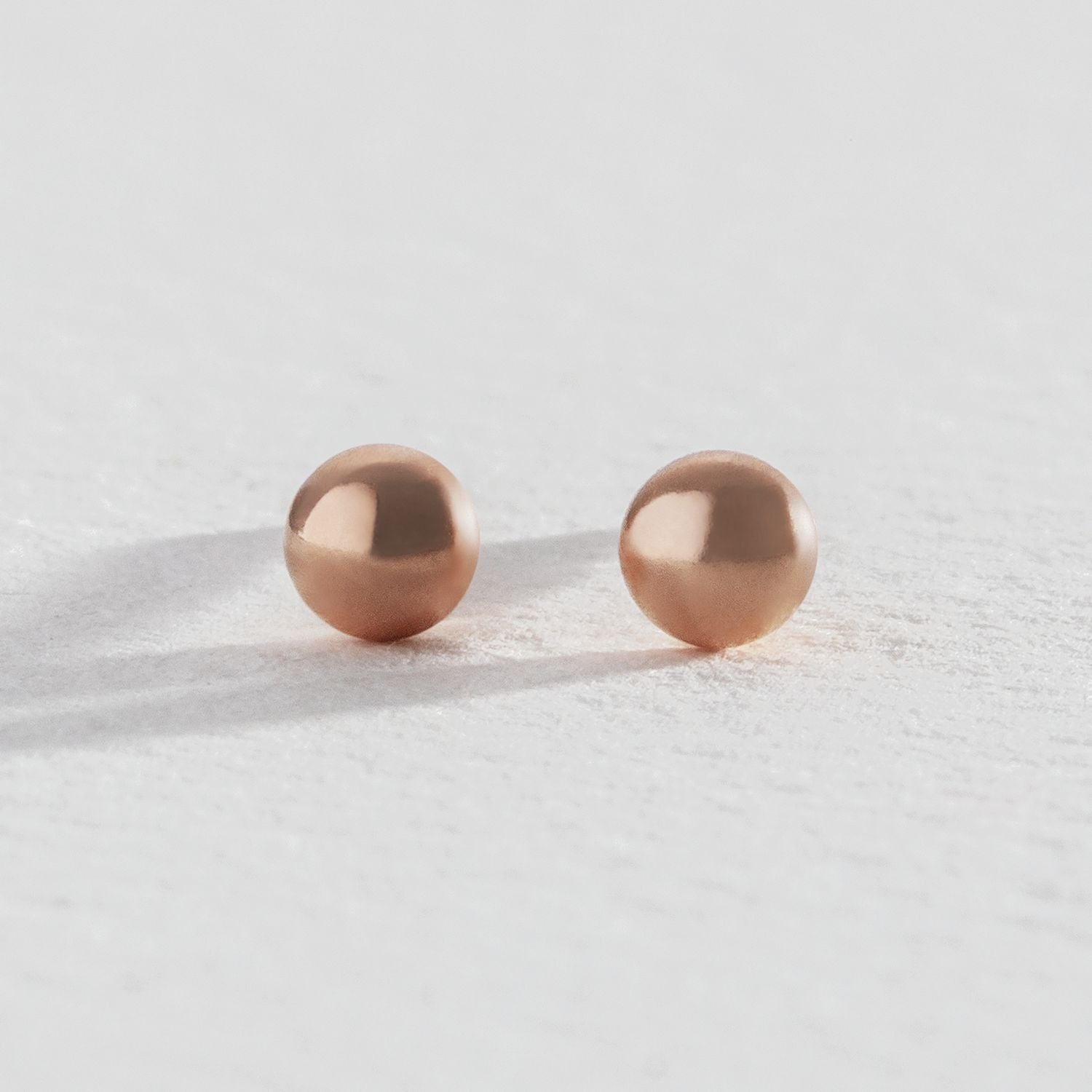 Revere rose gold ball stud earrings (British brand)