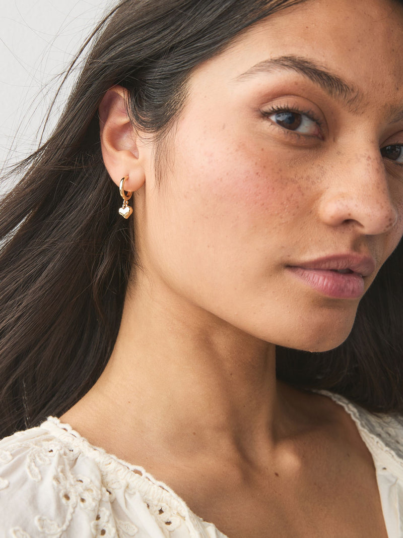 Mini gold tone heart hoop earrings, imported from the UK