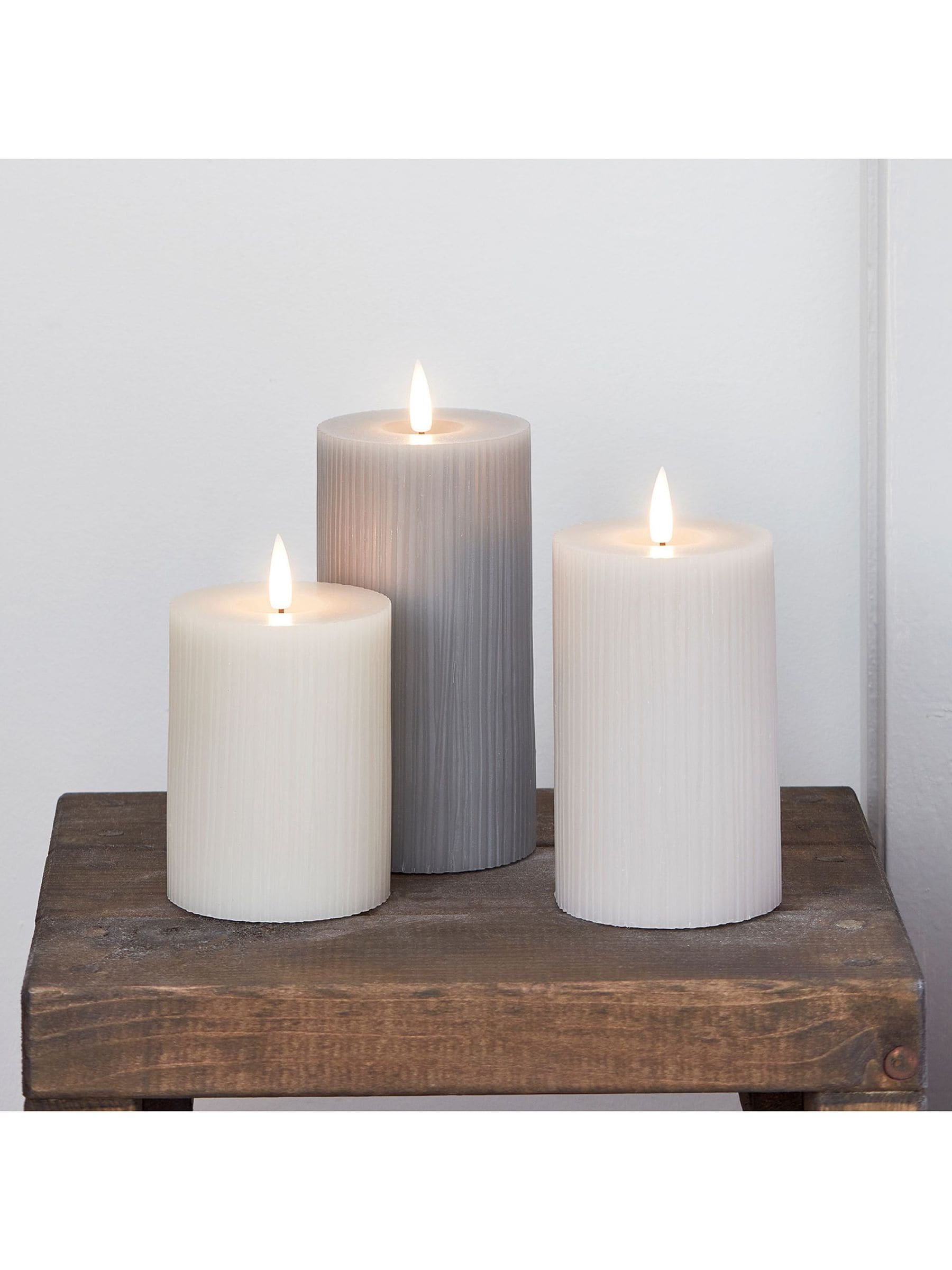 Lights4fun grey ribbed pillar LED candle trio with varying heights, UK version