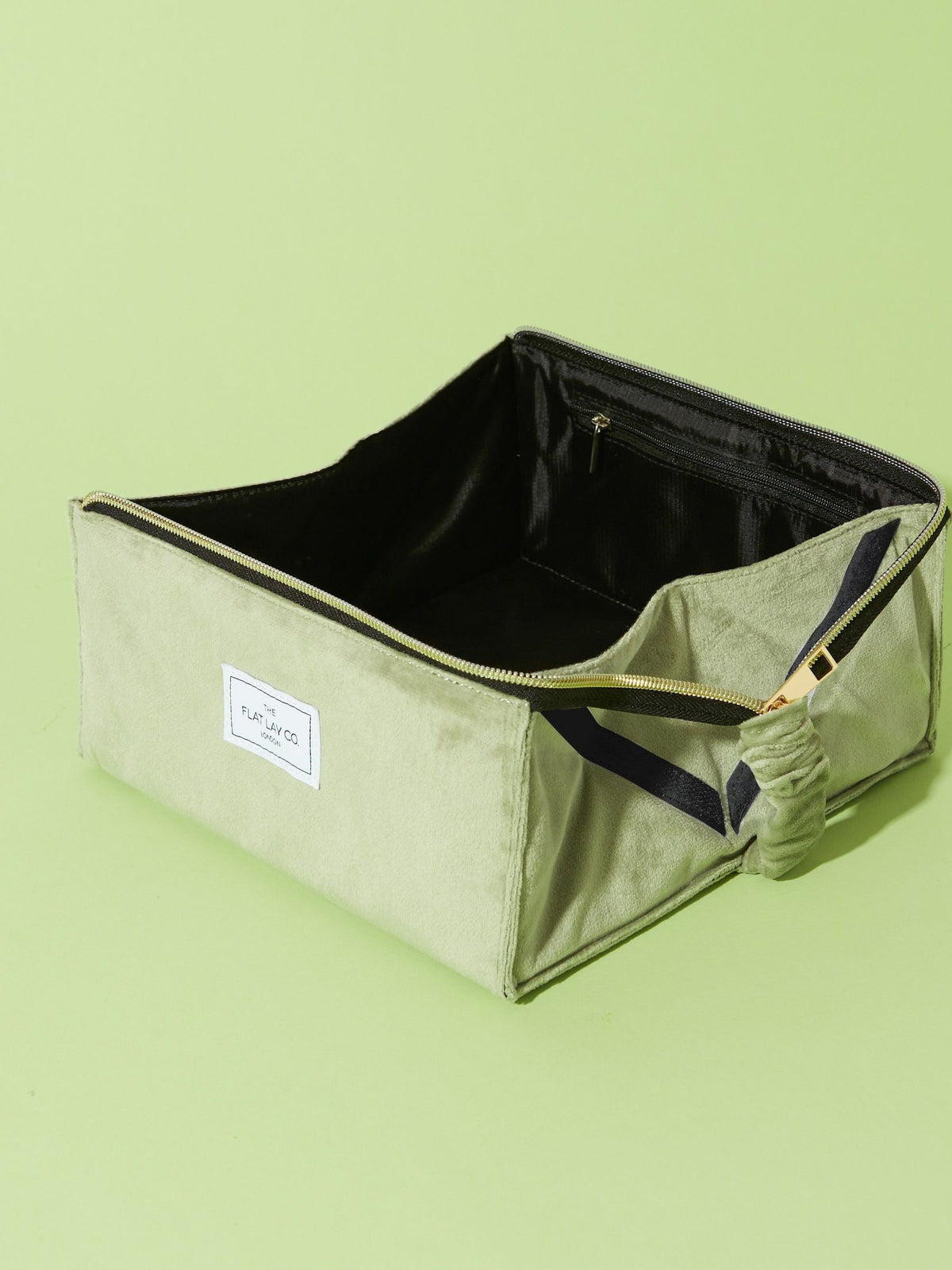Flat Lay Co. sage green velvet makeup bag (British brand)