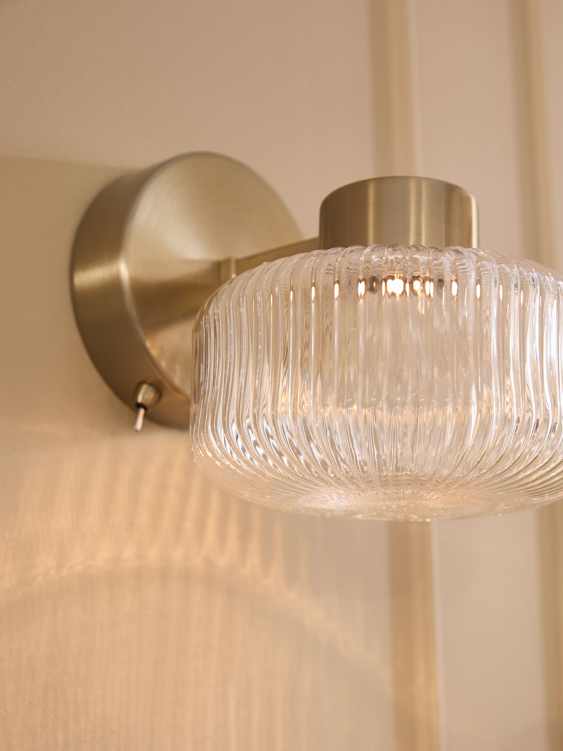 Brass rechargeable Lexington wall light with ribbed glass shade, imported from the UK