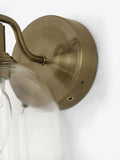 Gloucester wall light with clear glass and brass accents, UK version