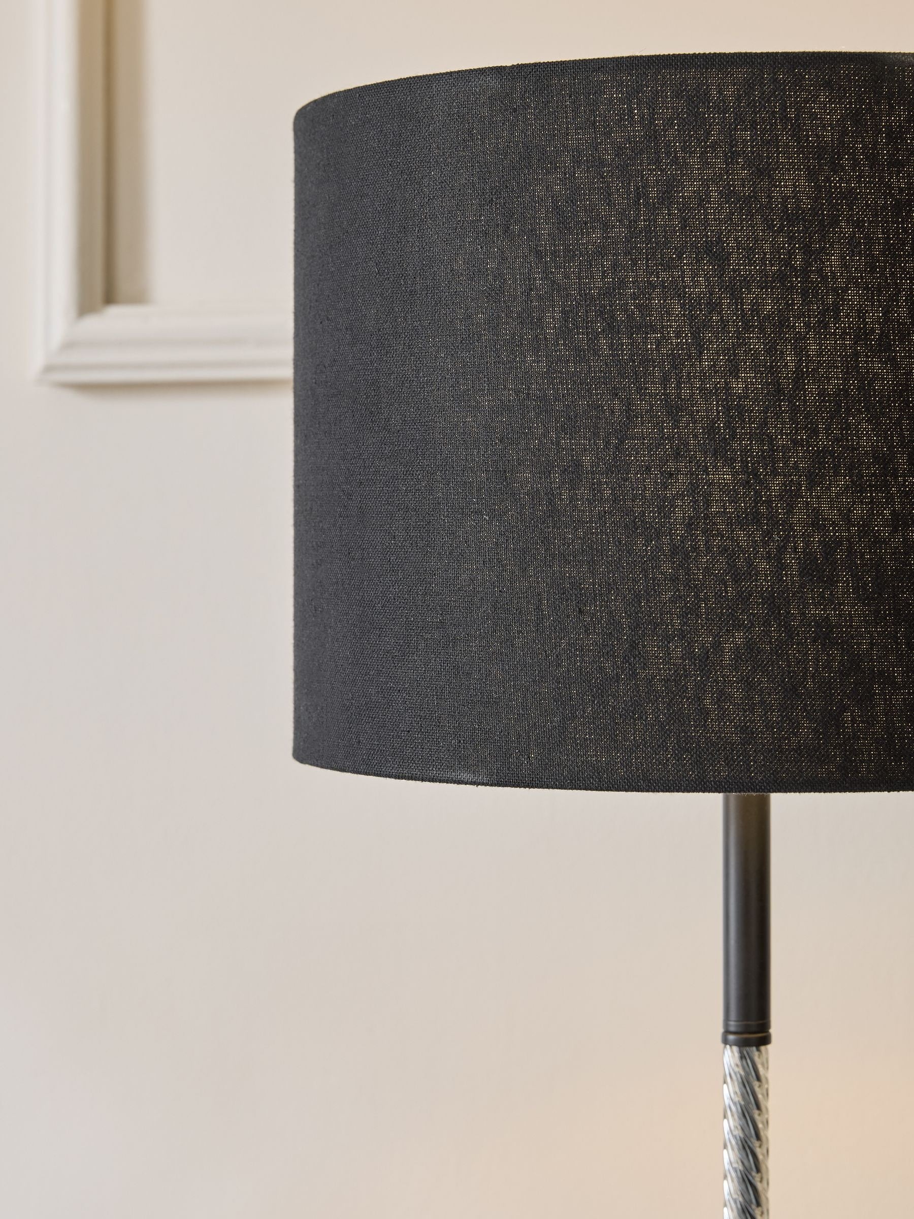 Sosandar black floor lamp with amber glass base, imported from the UK