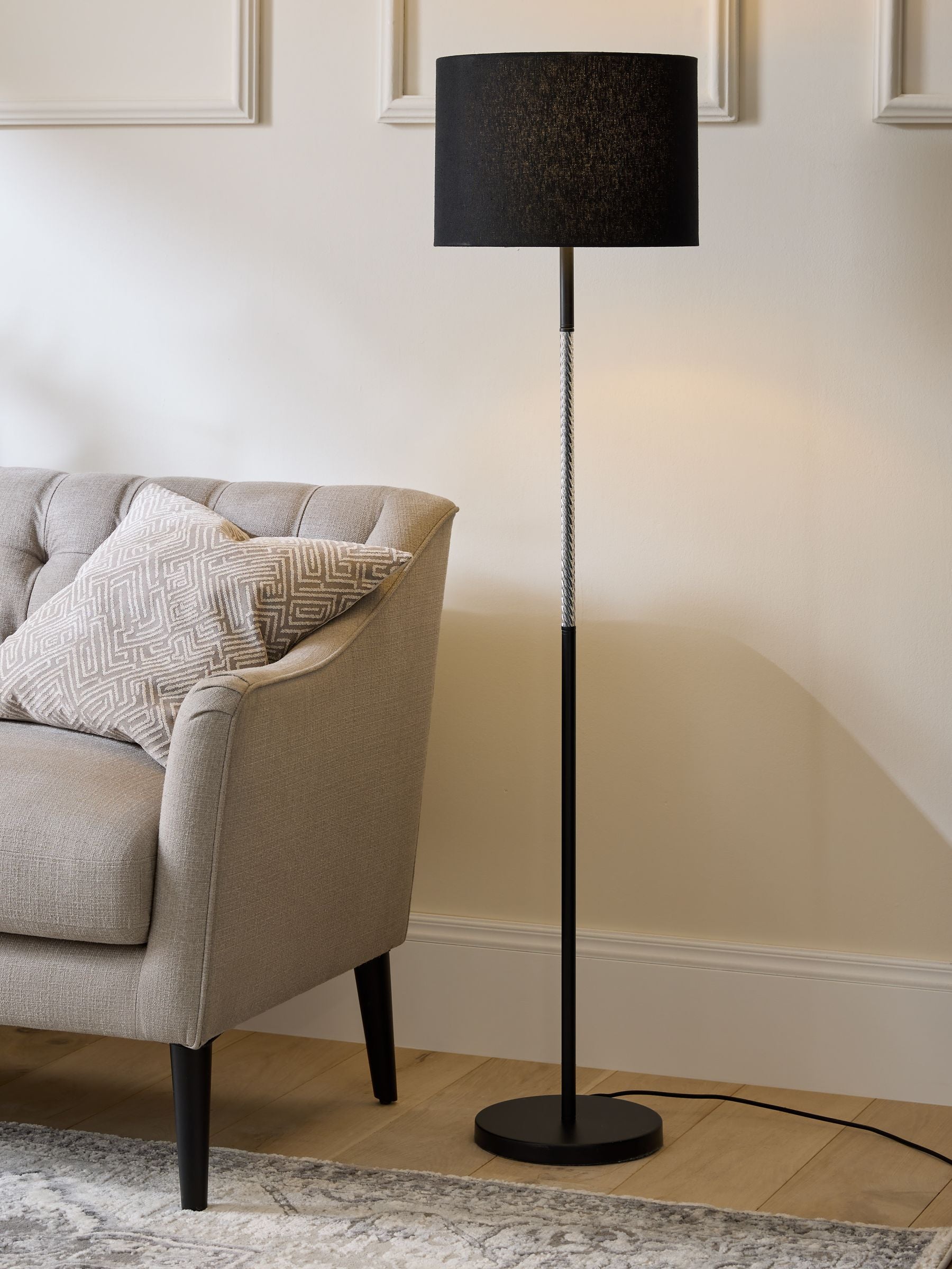Sosandar black floor lamp with amber glass base, imported from the UK