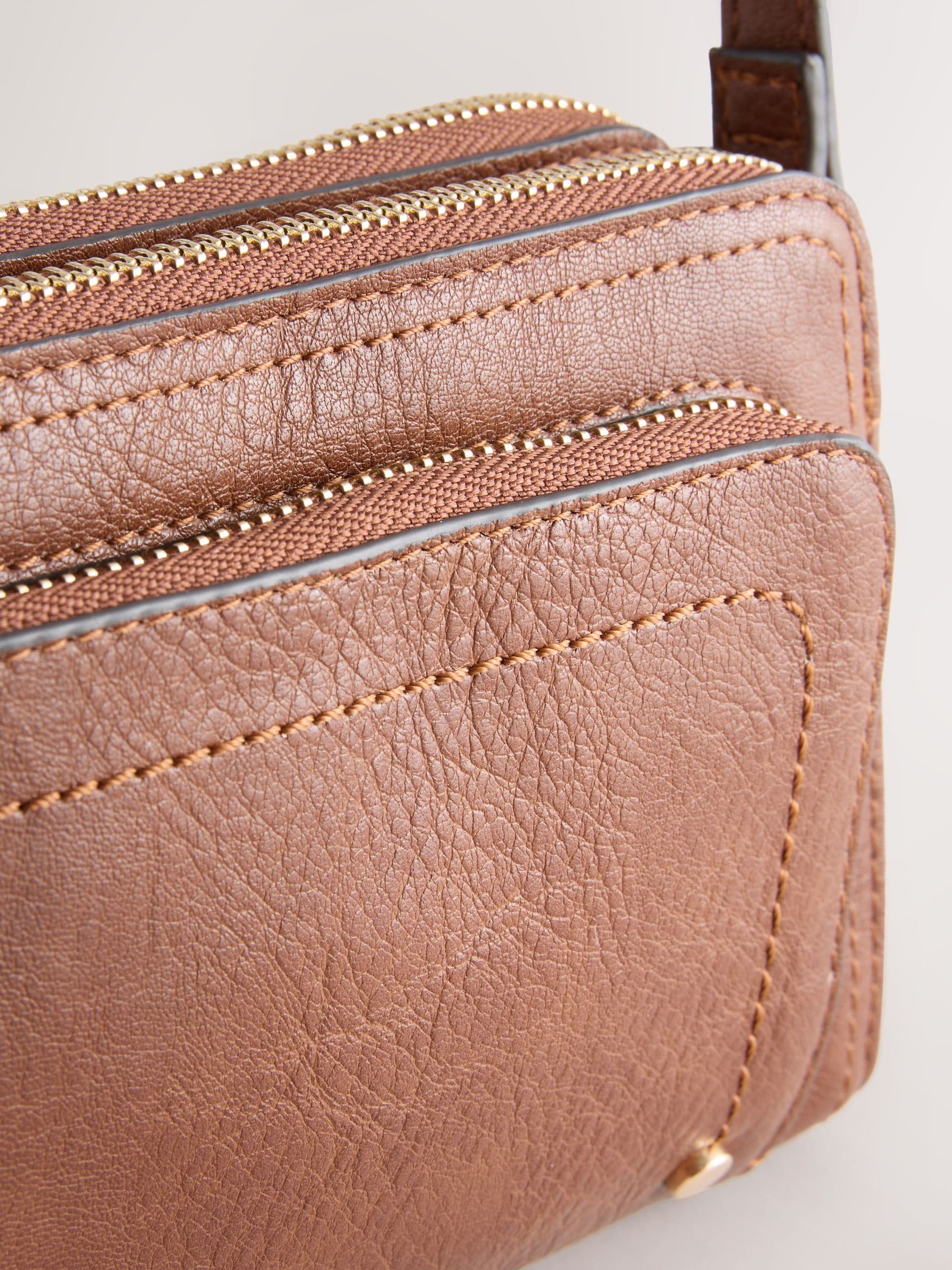 Black double zip cross body bag with adjustable strap, imported from the UK