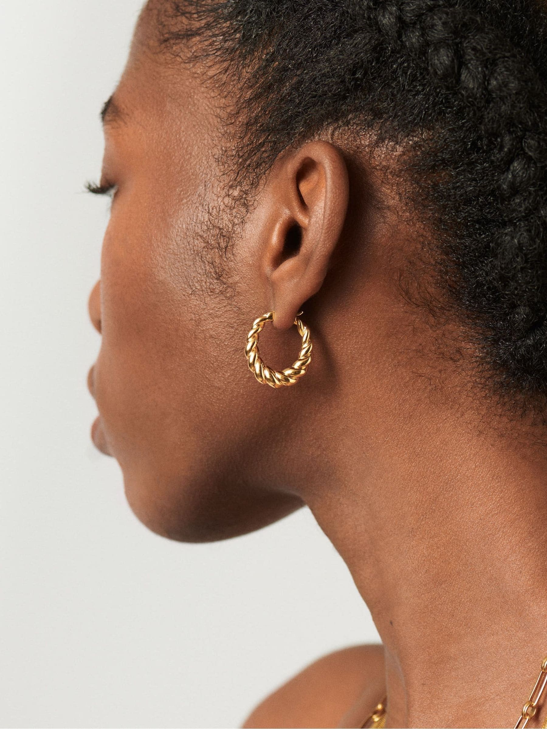 Missoma gold tone twisted tidal small hoop earrings, imported from the UK