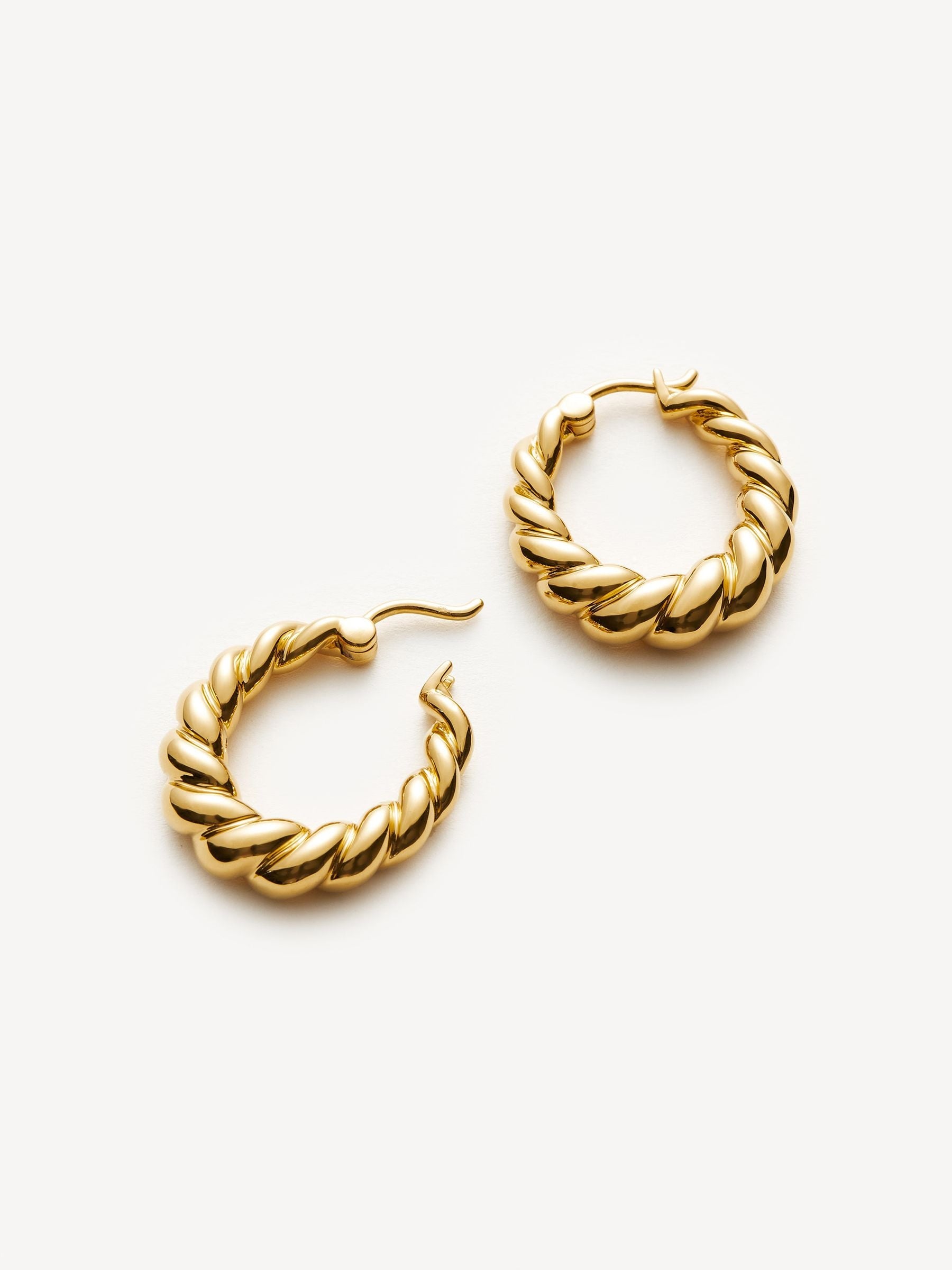 Missoma gold tone twisted tidal small hoop earrings, imported from the UK