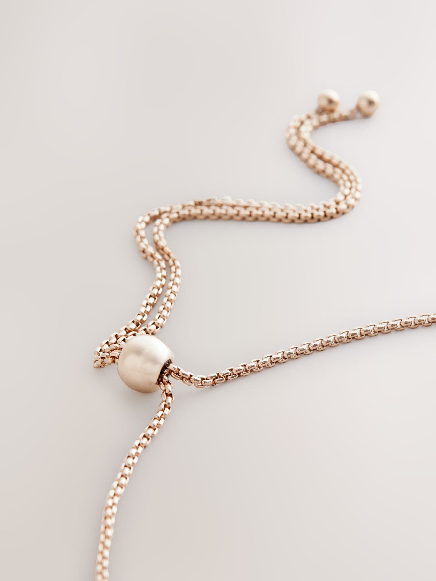 Gold tone sparkle pearl effect pully necklace and bracelet set, UK version