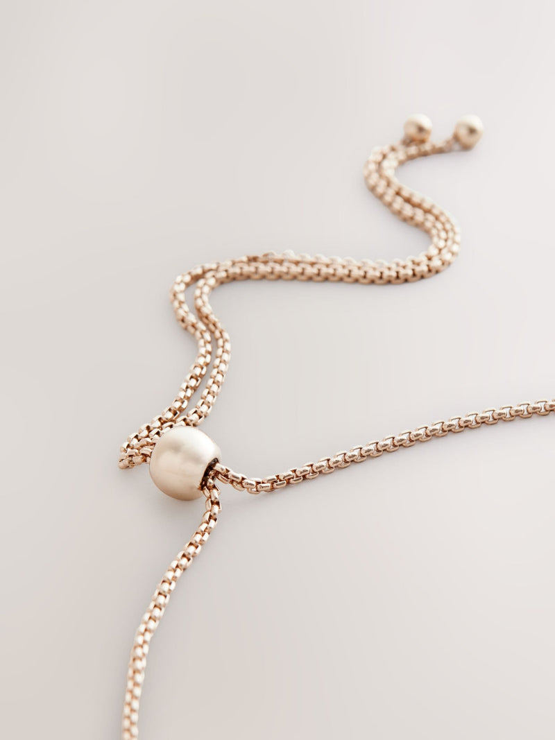 Gold tone sparkle pearl effect pully necklace and bracelet set, UK version