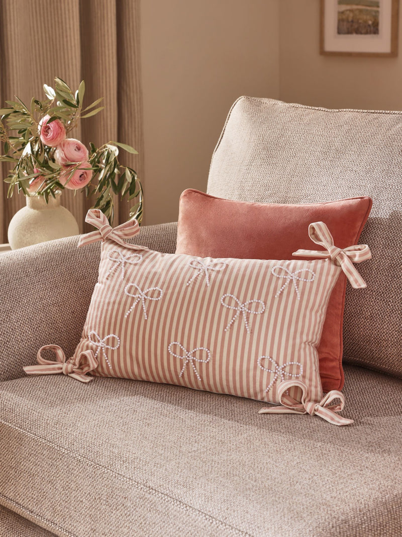 Pink velvet cushion with pearl bow detailing 30x50cm (British brand)