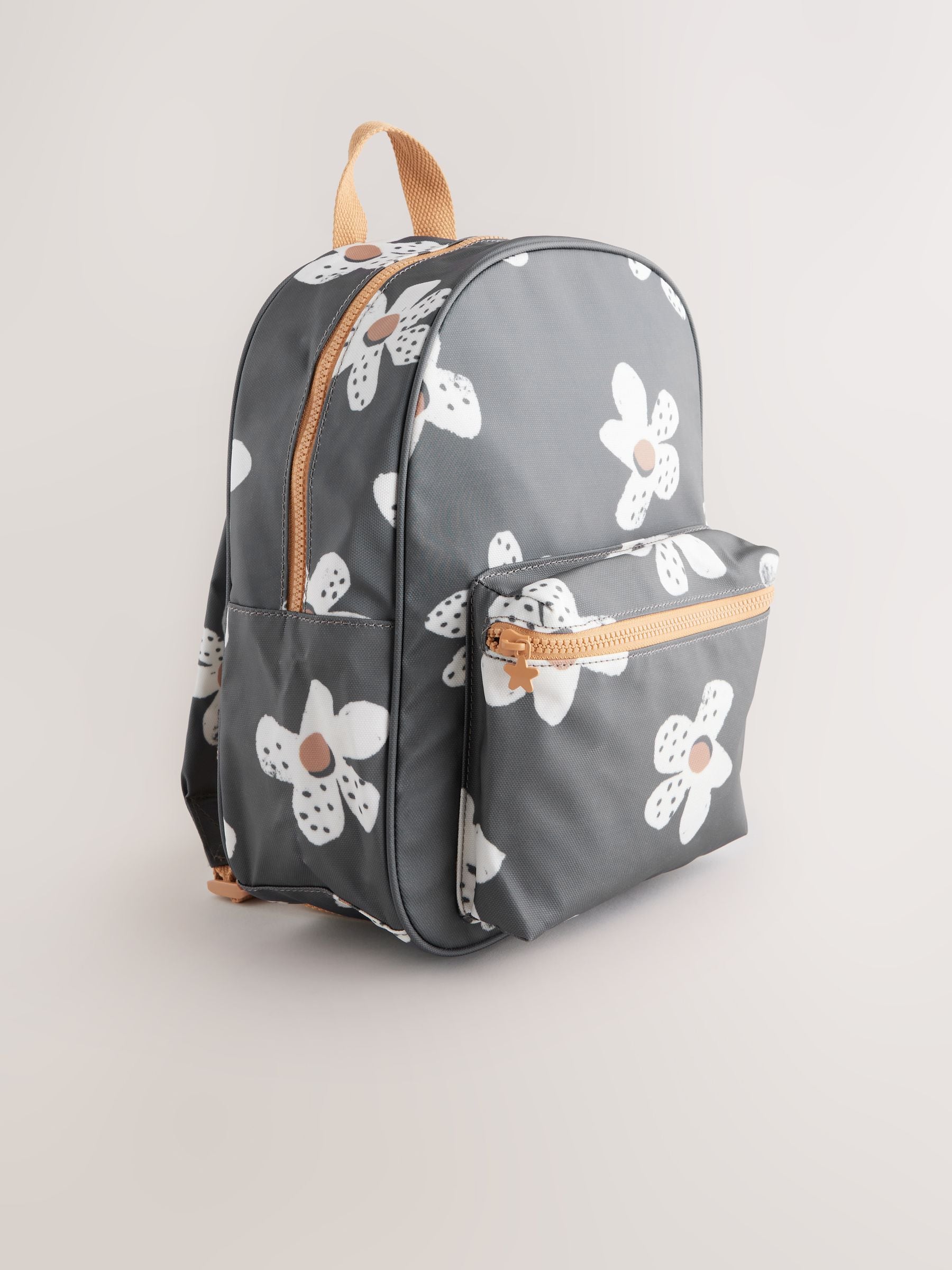 Black floral backpack with daisy design and adjustable straps, UK version