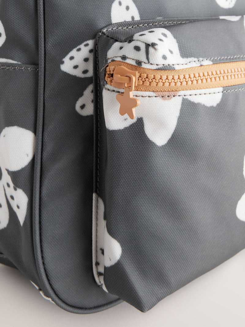Black floral backpack with daisy design and adjustable straps, UK version