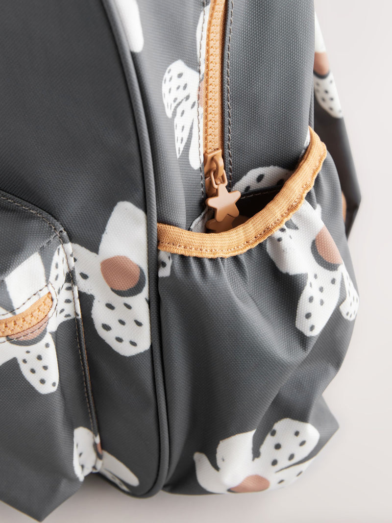 Black floral backpack with daisy design and adjustable straps, UK version