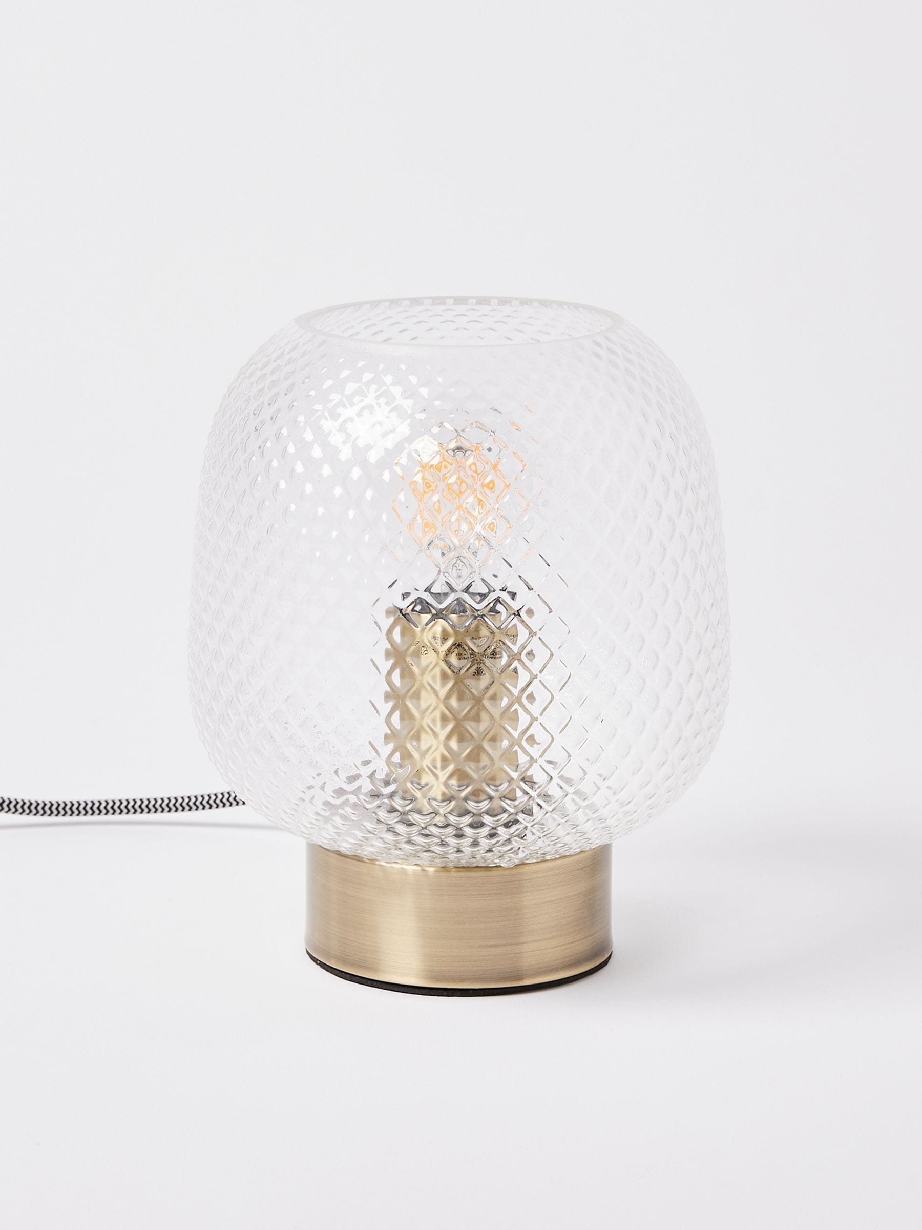 Oliver Bonas table lantern with textured glass shade and brass base, imported from the UK