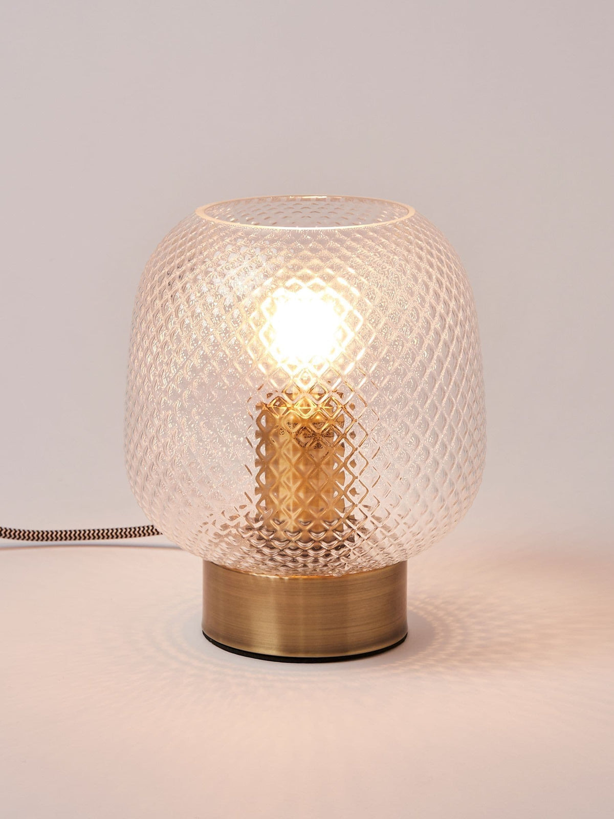 Oliver Bonas table lantern with textured glass shade and brass base, imported from the UK