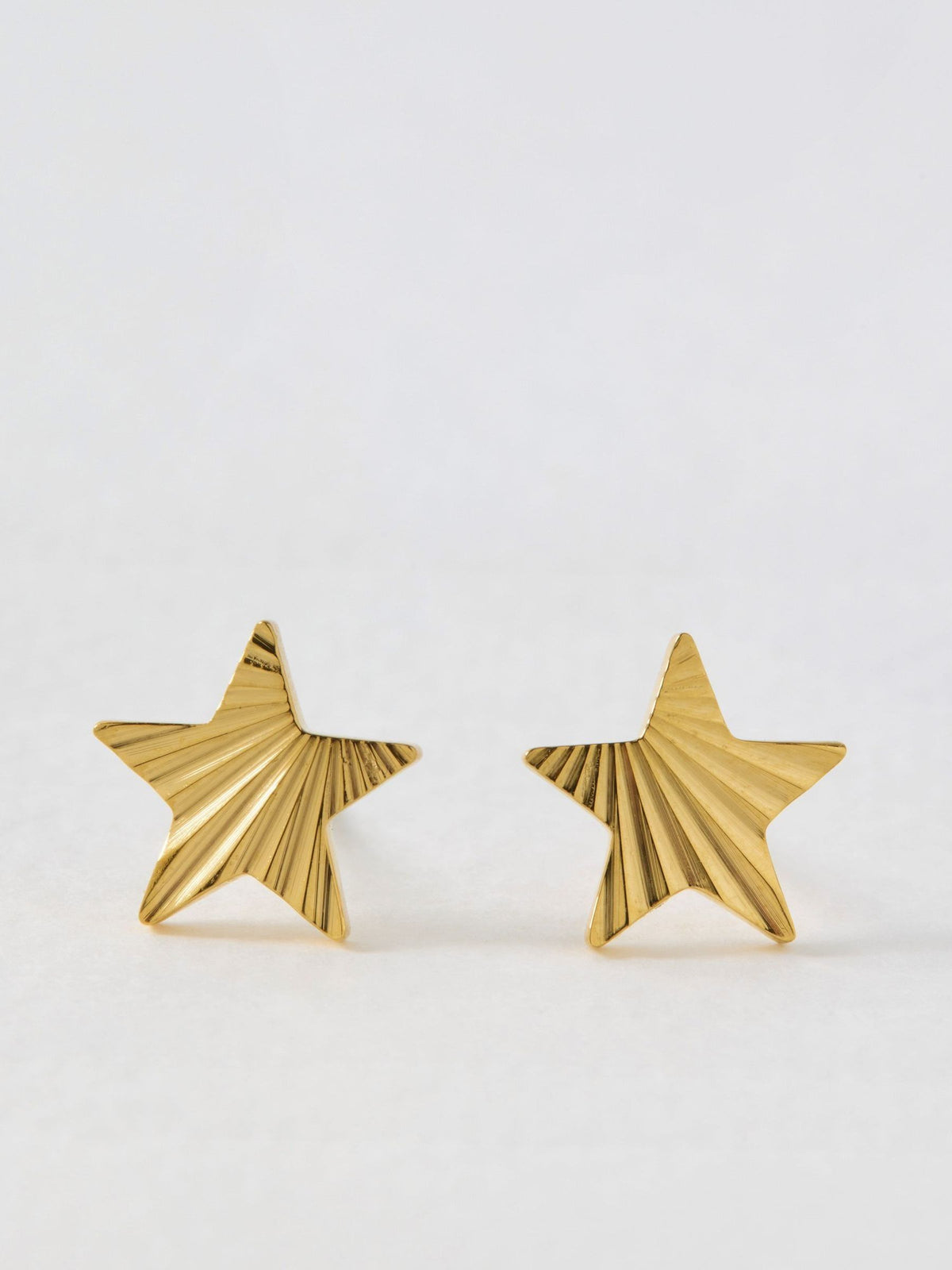 Oliver Bonas gold tone star stud earrings, imported from the UK