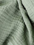 Lark muslin crinkle cotton throw in eucalyptus green (British brand)