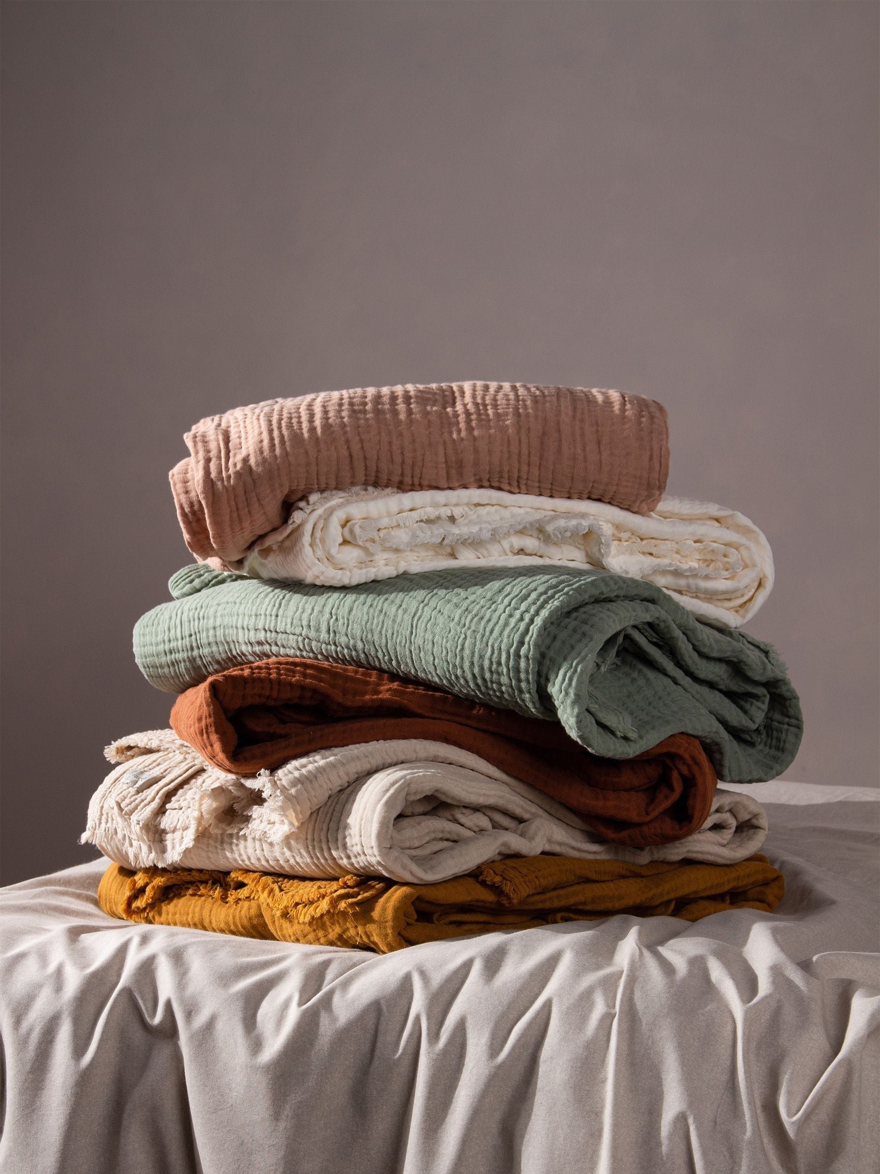 Lark muslin crinkle cotton throw in eucalyptus green (British brand)