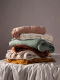 Lark muslin crinkle cotton throw in eucalyptus green (British brand)