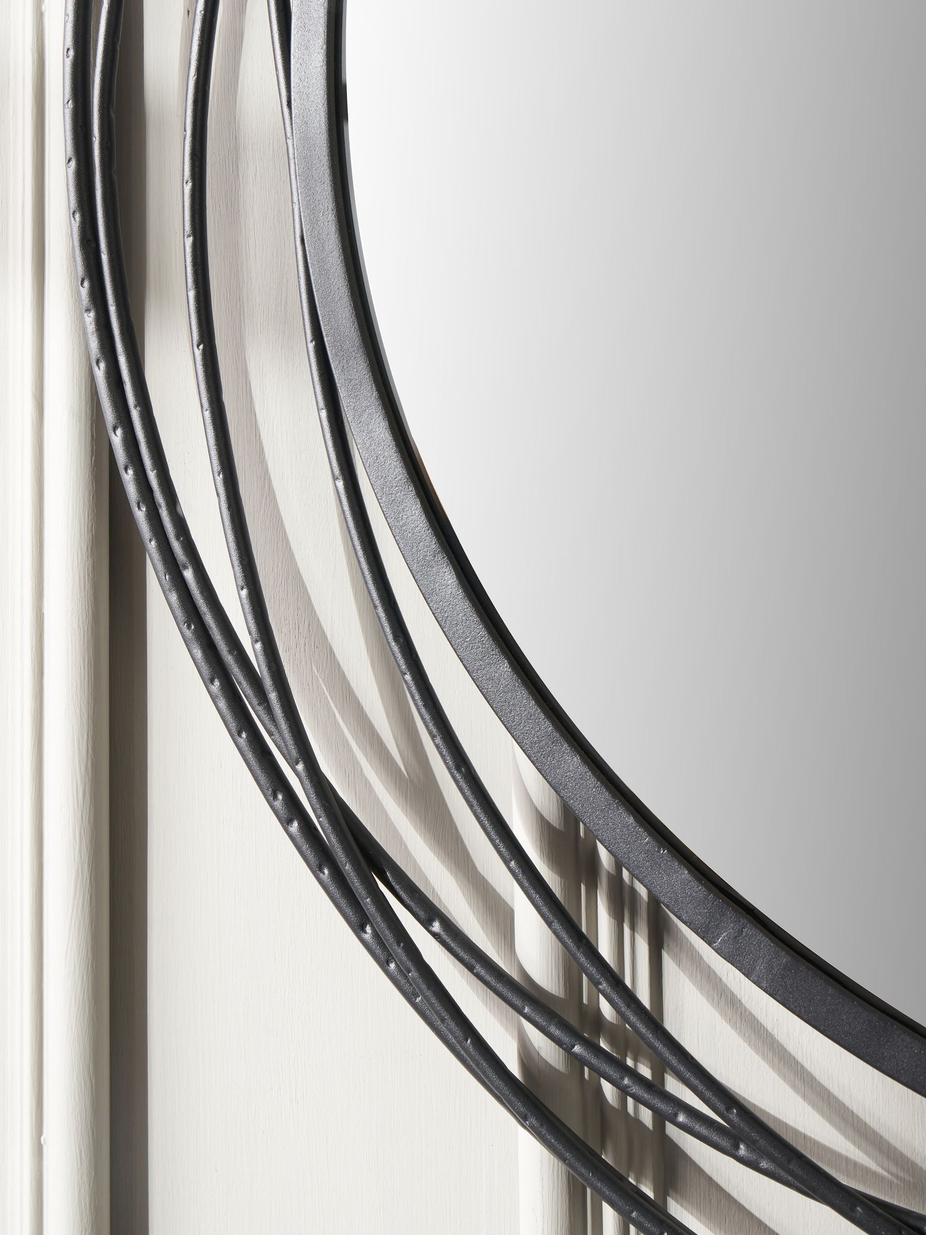 Pacific black metal swirl round wall mirror, imported from the UK