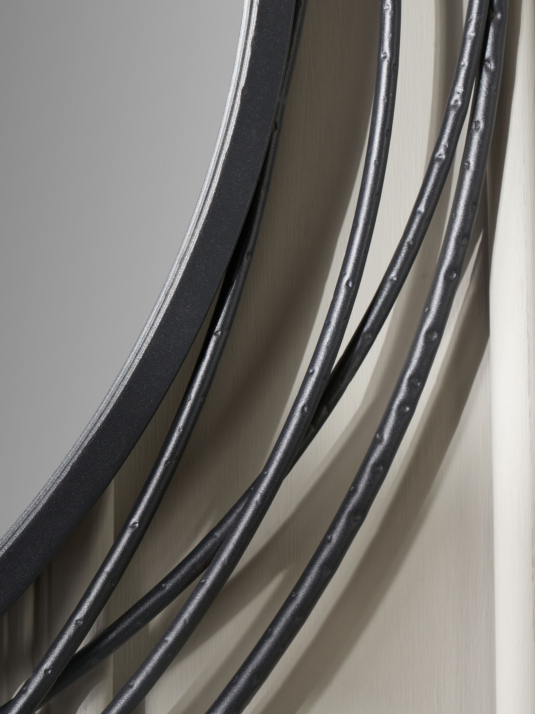 Pacific black metal swirl round wall mirror, imported from the UK
