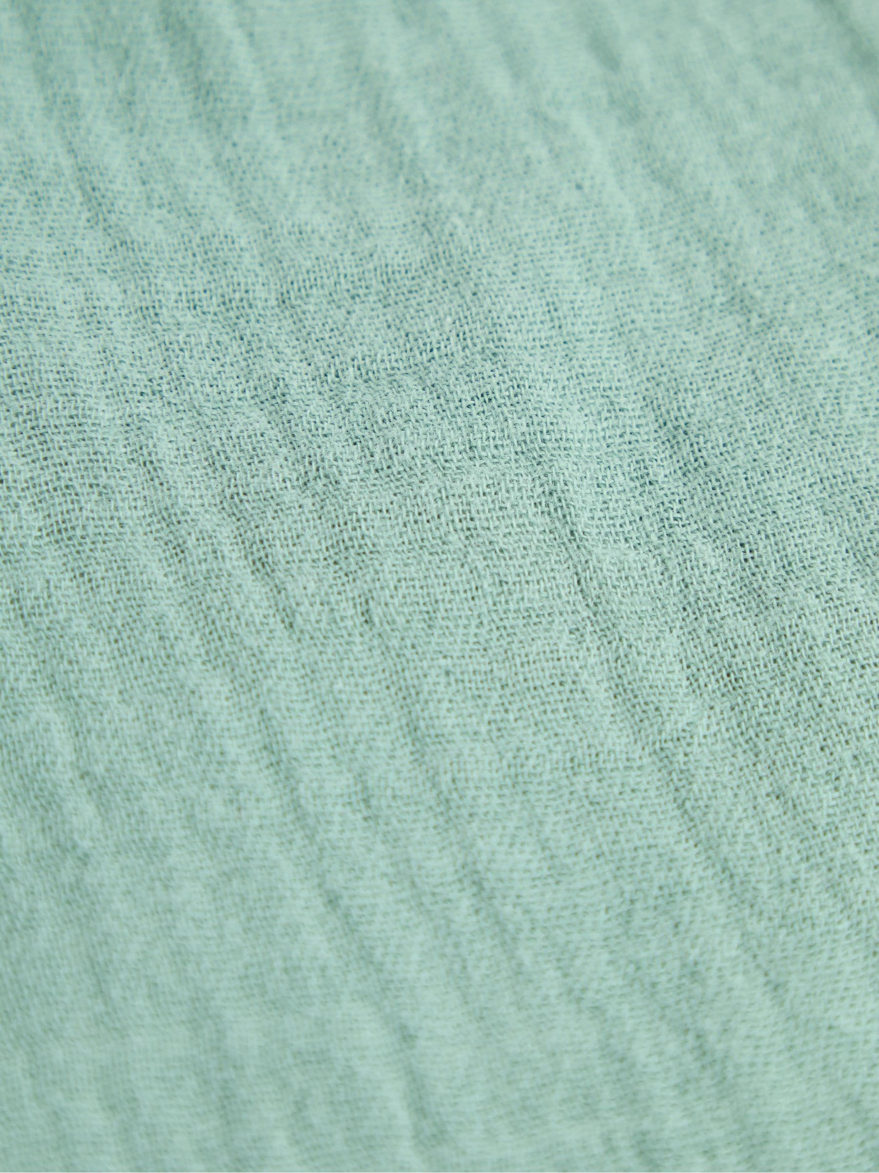 JoJo Maman Bébé green muslin frill bib, UK version