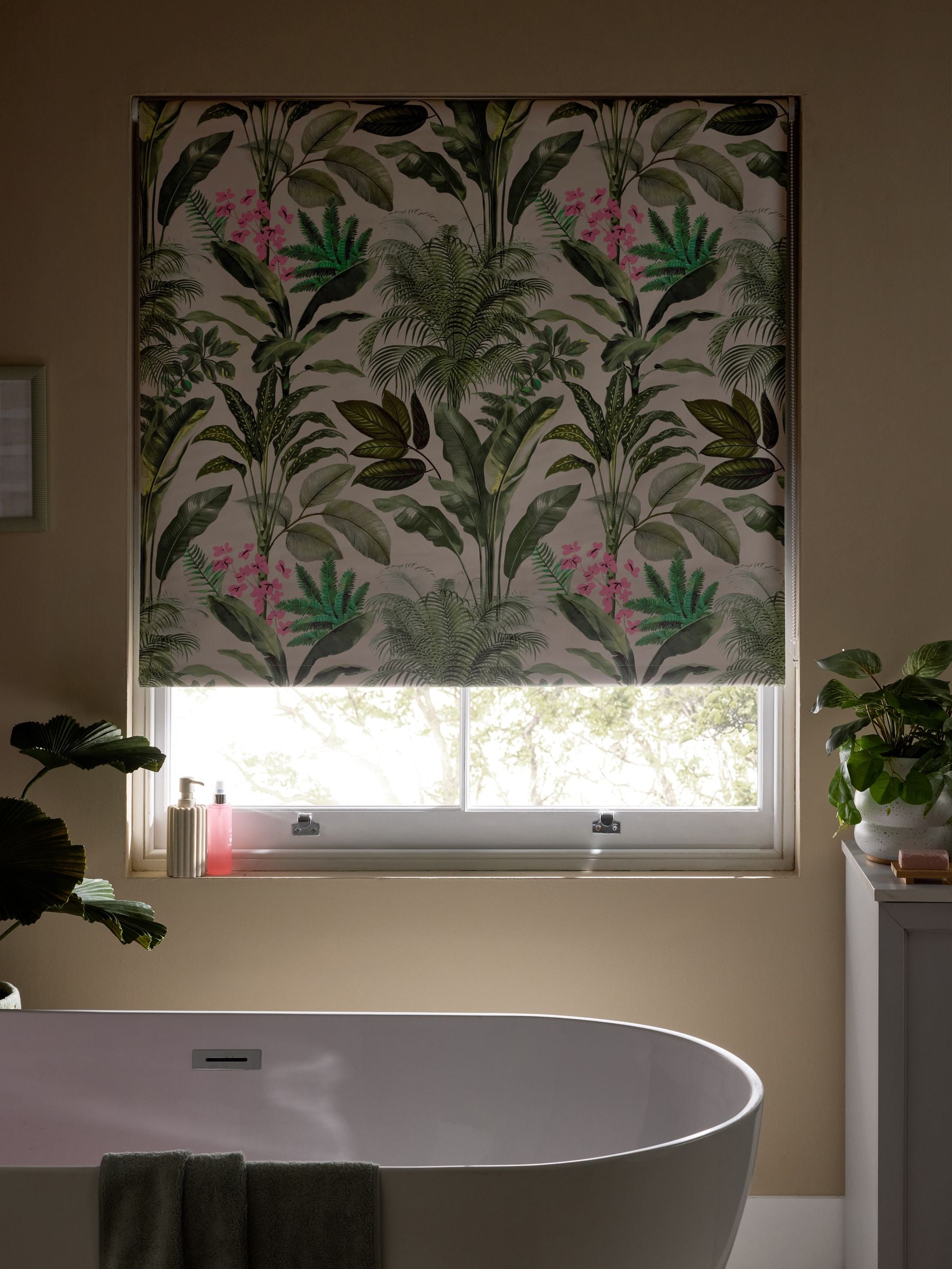 Tropical leaf print blackout roller blind in green and pink, UK version