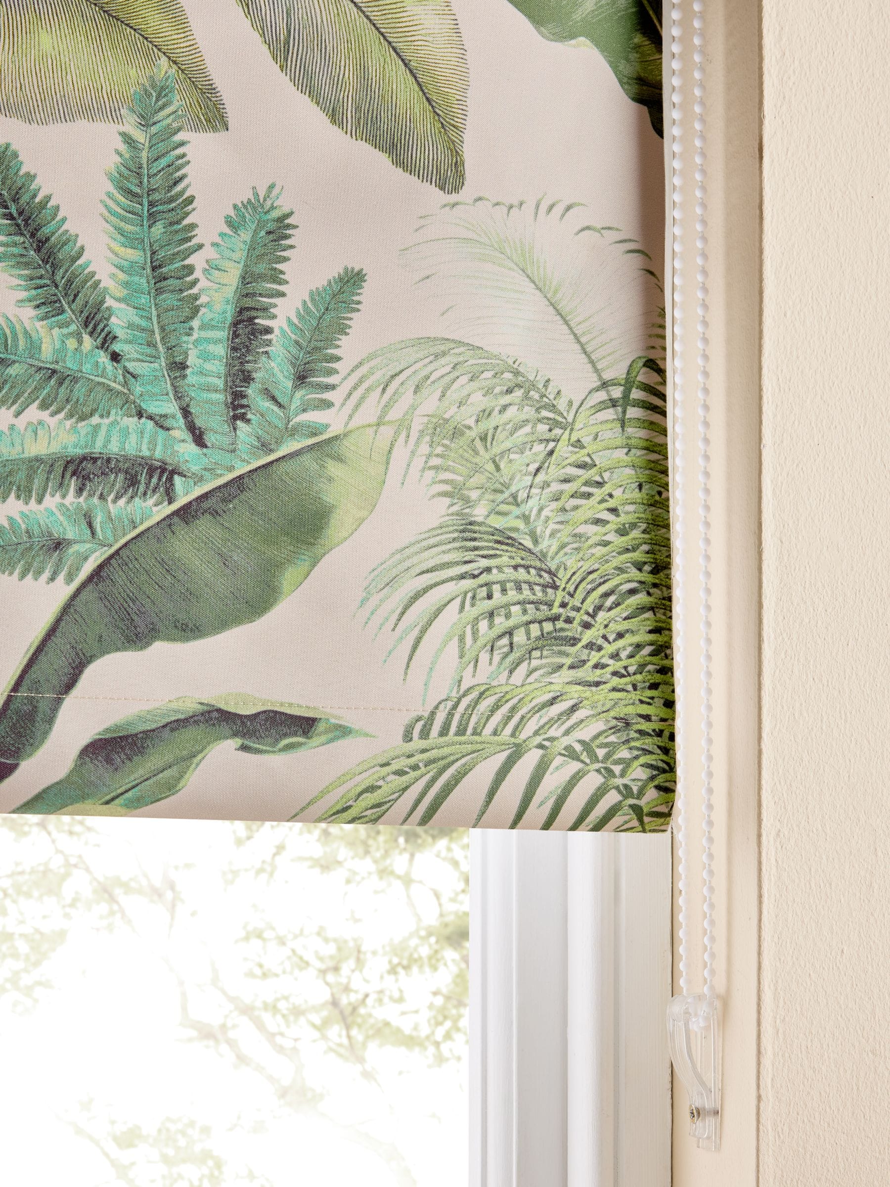 Tropical leaf print blackout roller blind in green and pink, UK version
