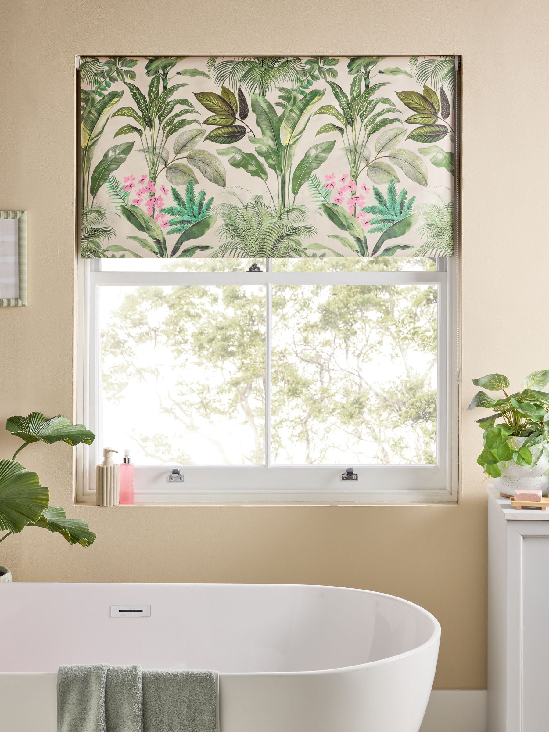 Tropical leaf print blackout roller blind in green and pink, UK version