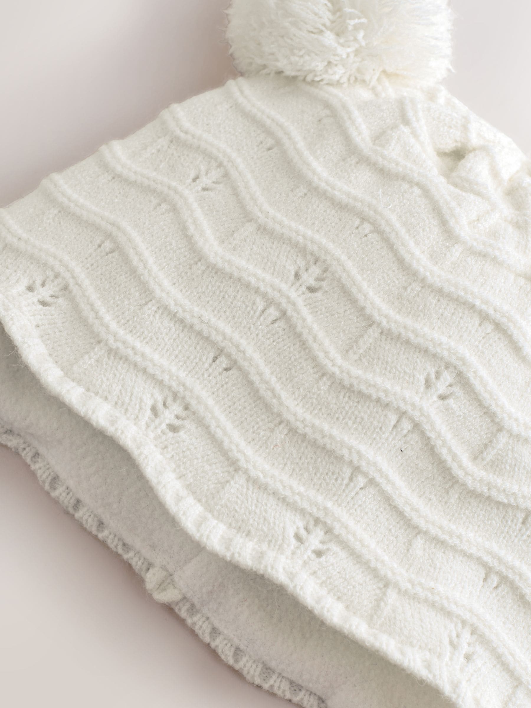 White knitted baby trapper hat double pom, imported from the UK