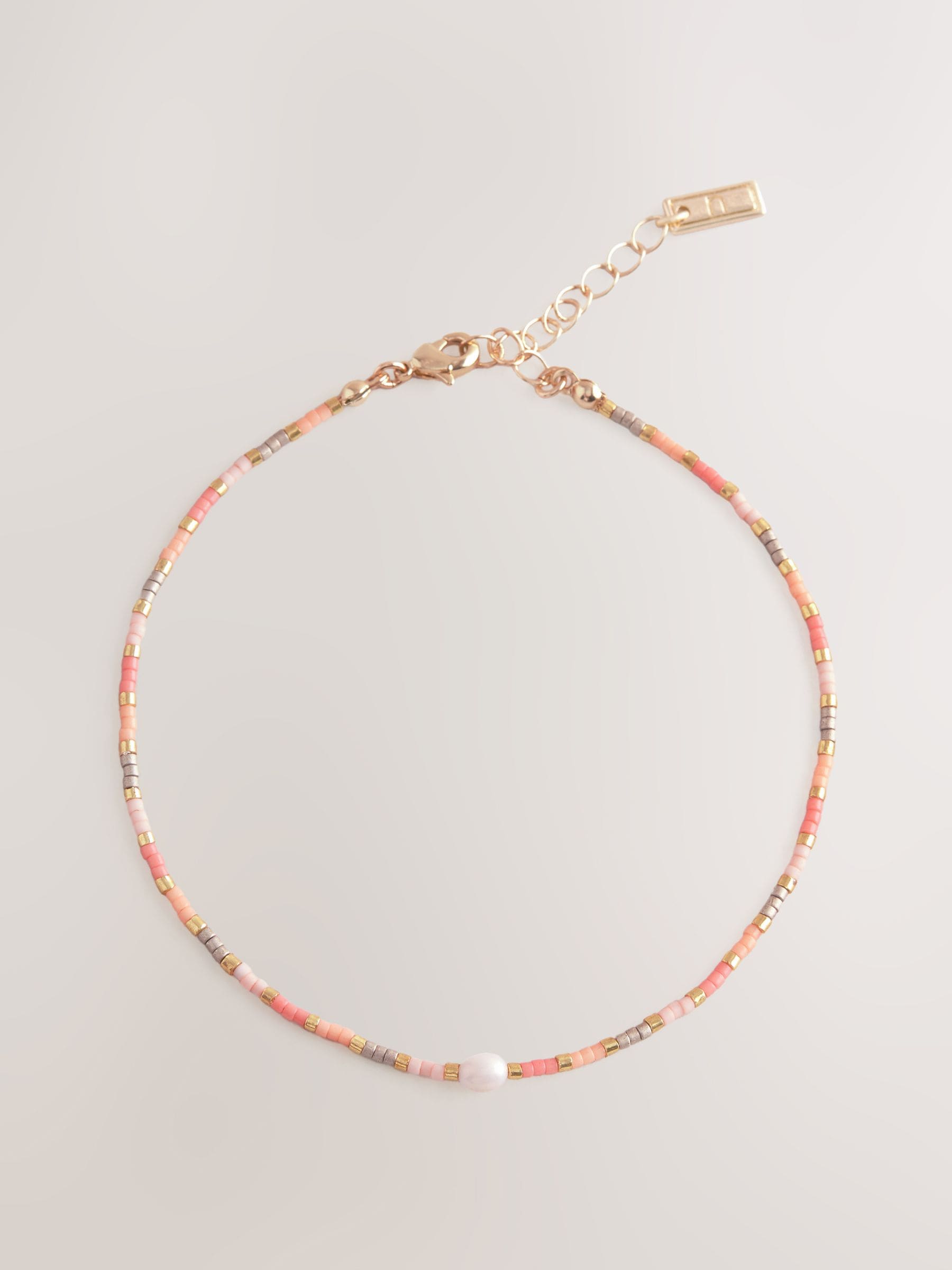 Orange beaded anklet, imported from the UK