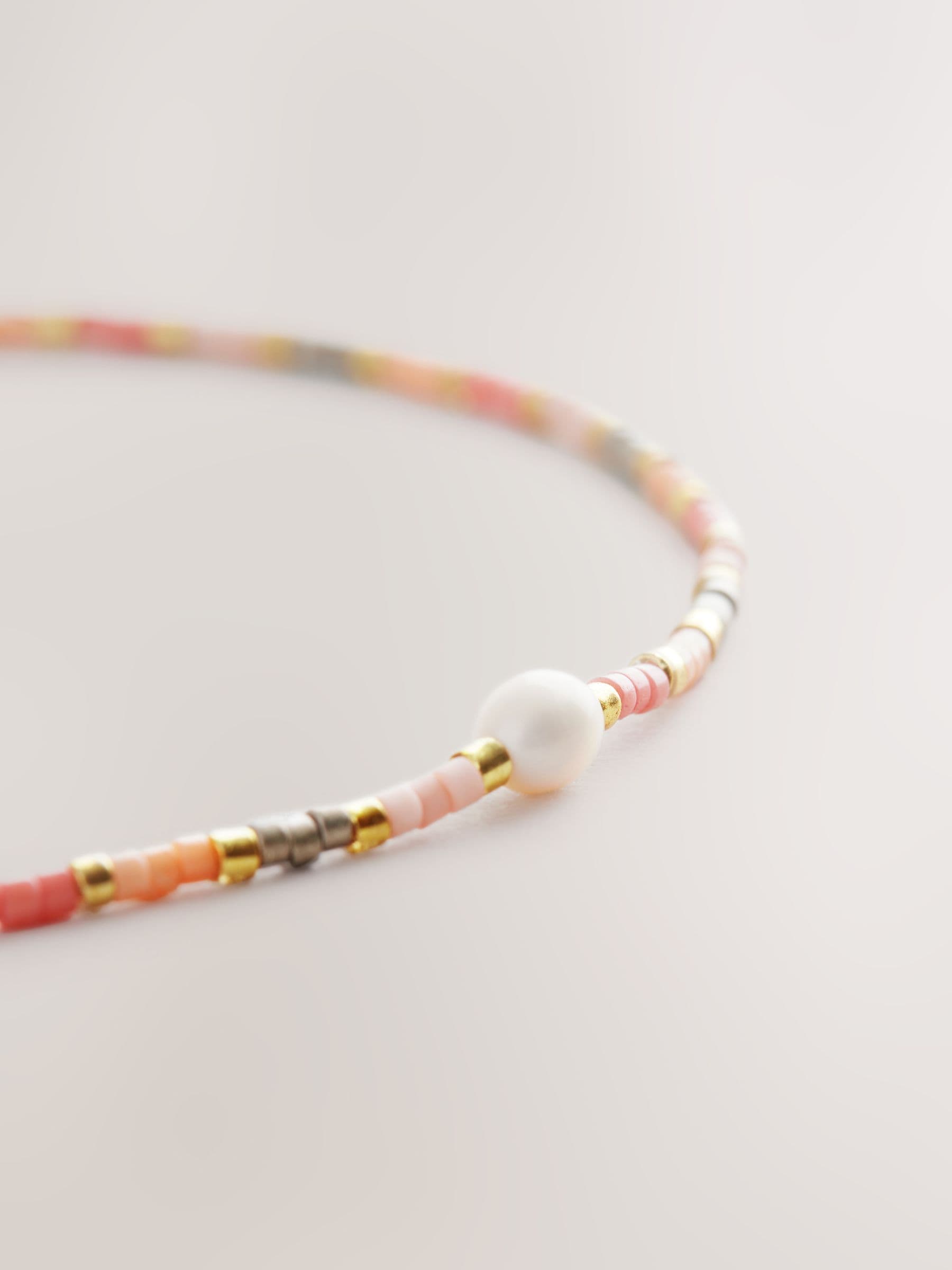 Orange beaded anklet, imported from the UK