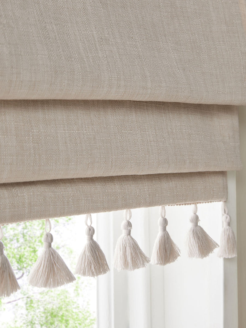 Natural textured blackout Roman blind with tassel edge, imported from the UK