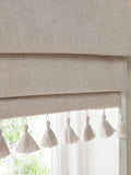 Natural textured blackout Roman blind with tassel edge, imported from the UK