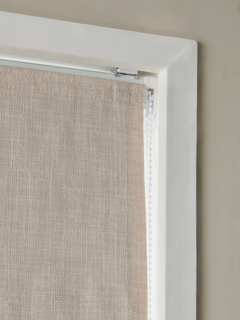 Natural textured blackout Roman blind with tassel edge, imported from the UK
