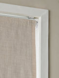 Natural textured blackout Roman blind with tassel edge, imported from the UK