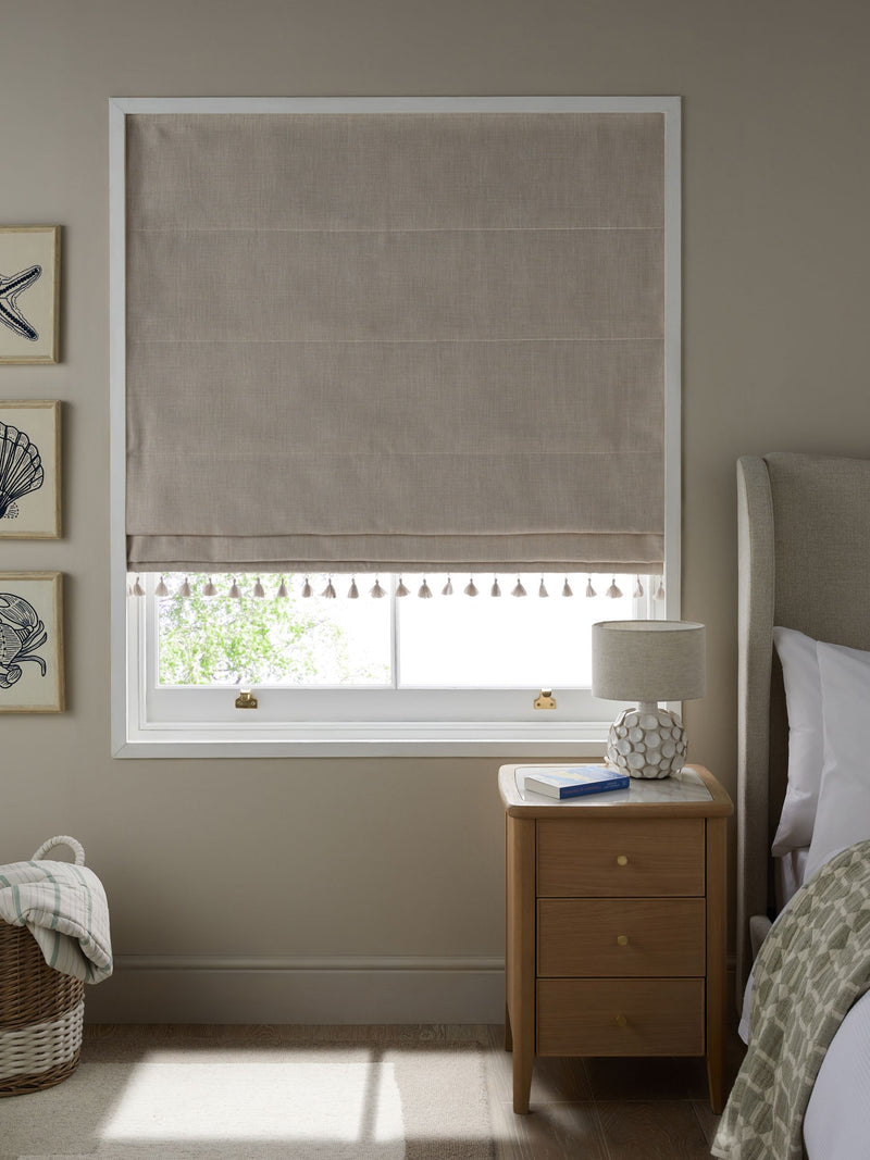 Natural textured blackout Roman blind with tassel edge, imported from the UK