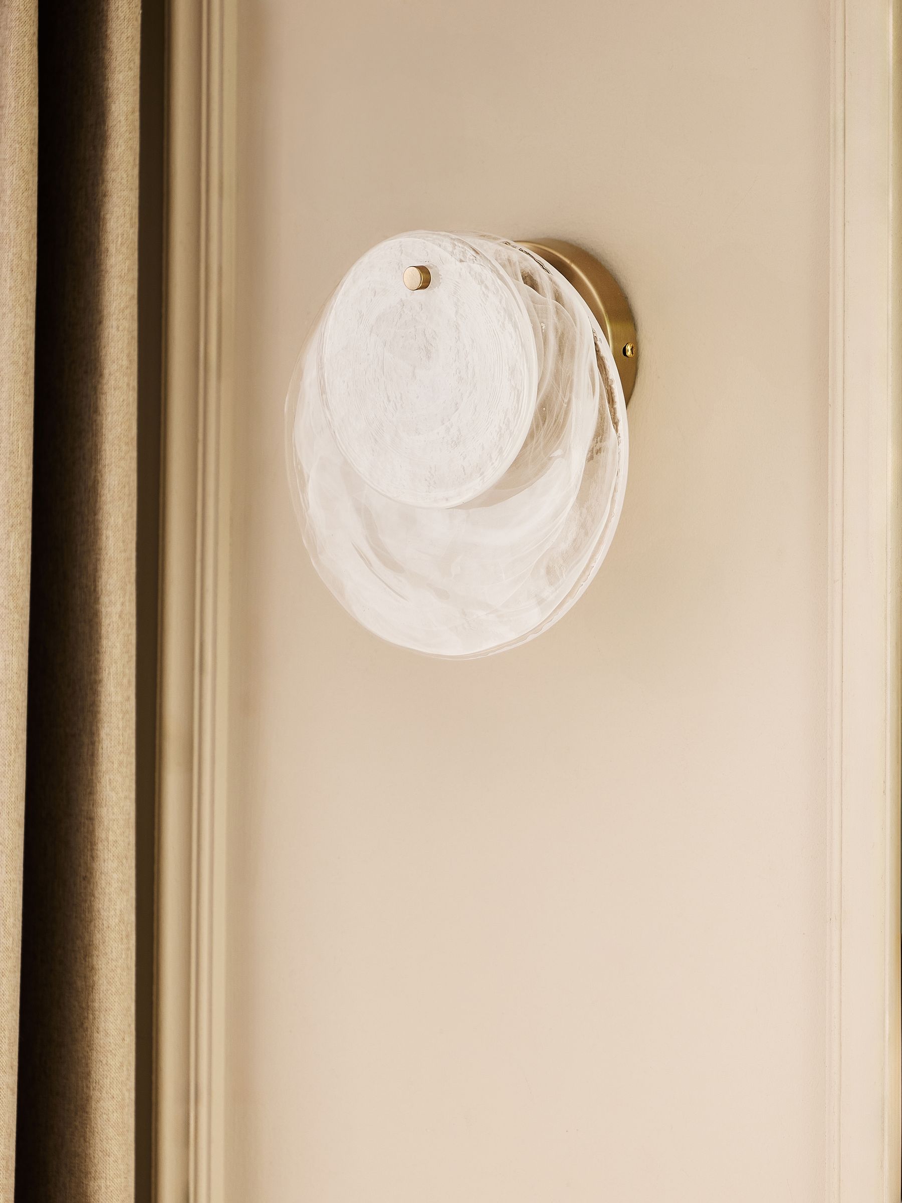 White Claremont wall light with brushed brass and opaque glass discs, imported from the UK