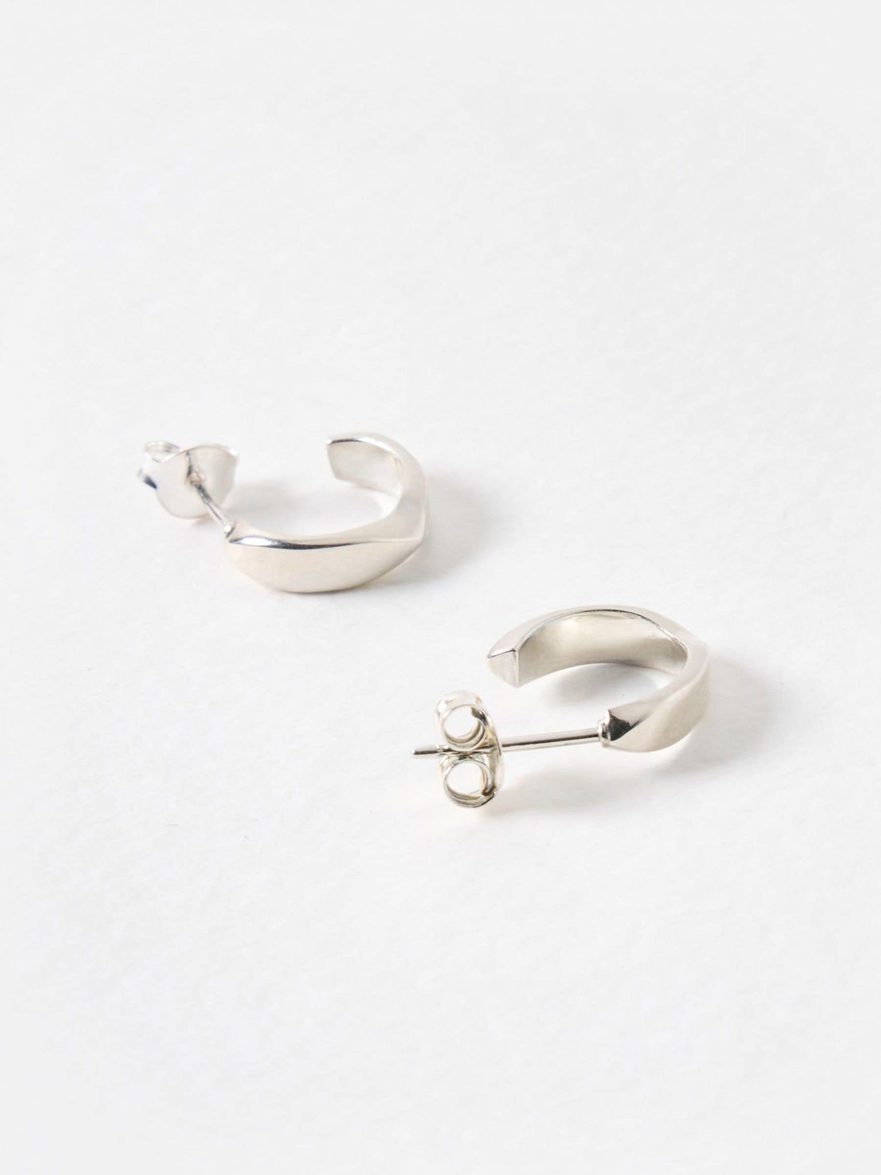 Oliver Bonas sterling silver huggie earrings with faceted surface, imported from the UK