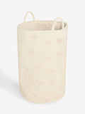 Cream bow laundry hamper with embroidered bows, imported from the UK