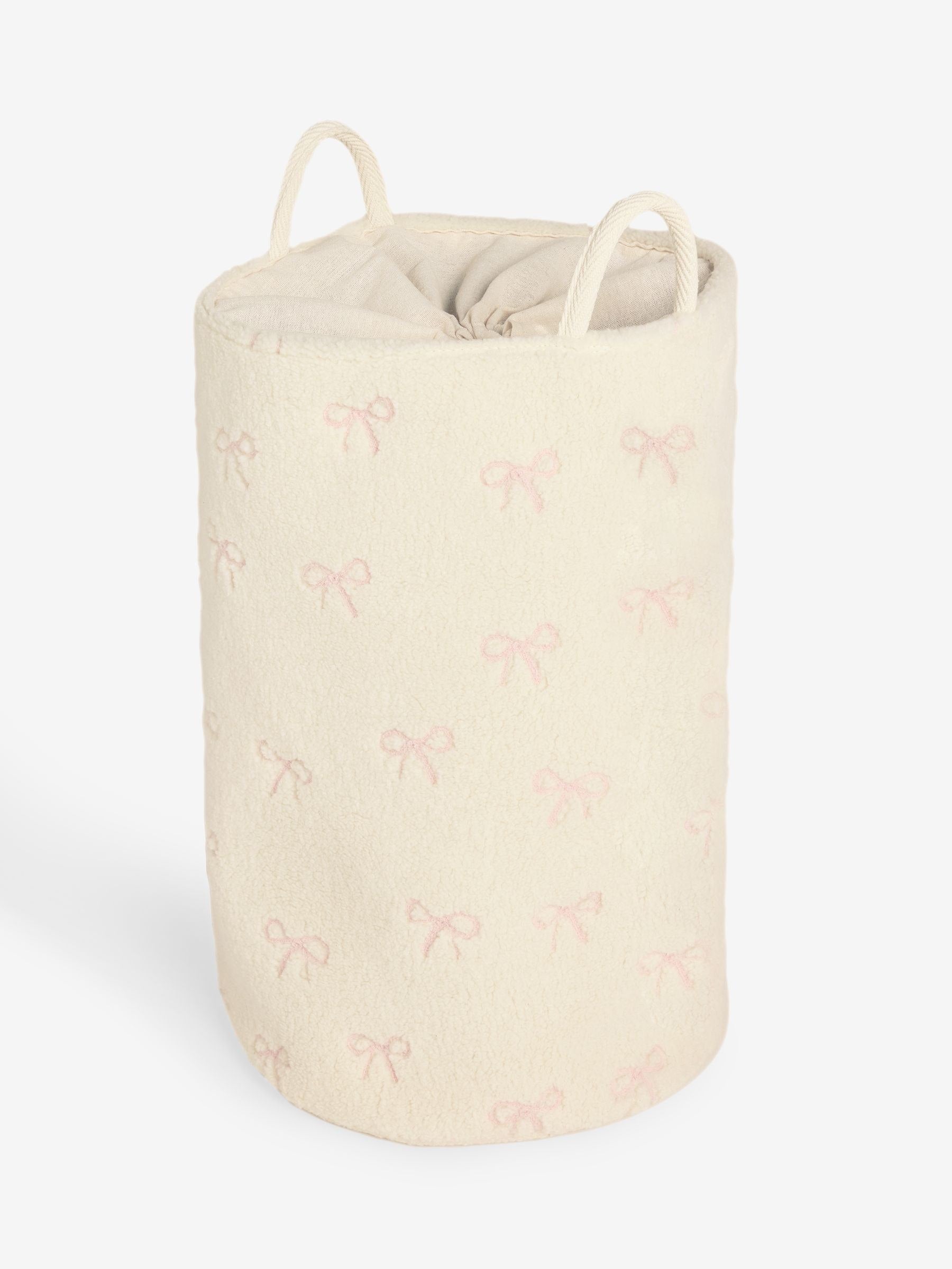 Cream bow laundry hamper with embroidered bows, imported from the UK