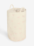 Cream bow laundry hamper with embroidered bows, imported from the UK