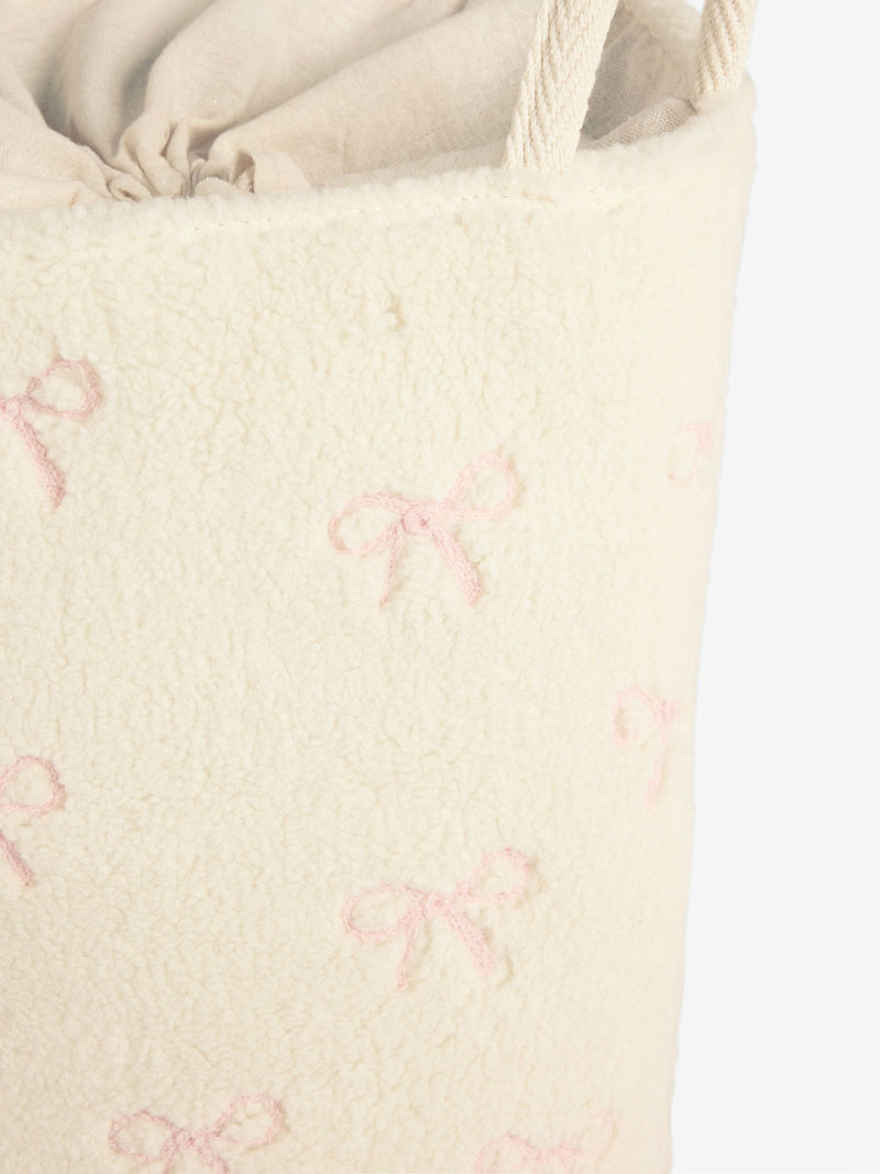 Cream bow laundry hamper with embroidered bows, imported from the UK