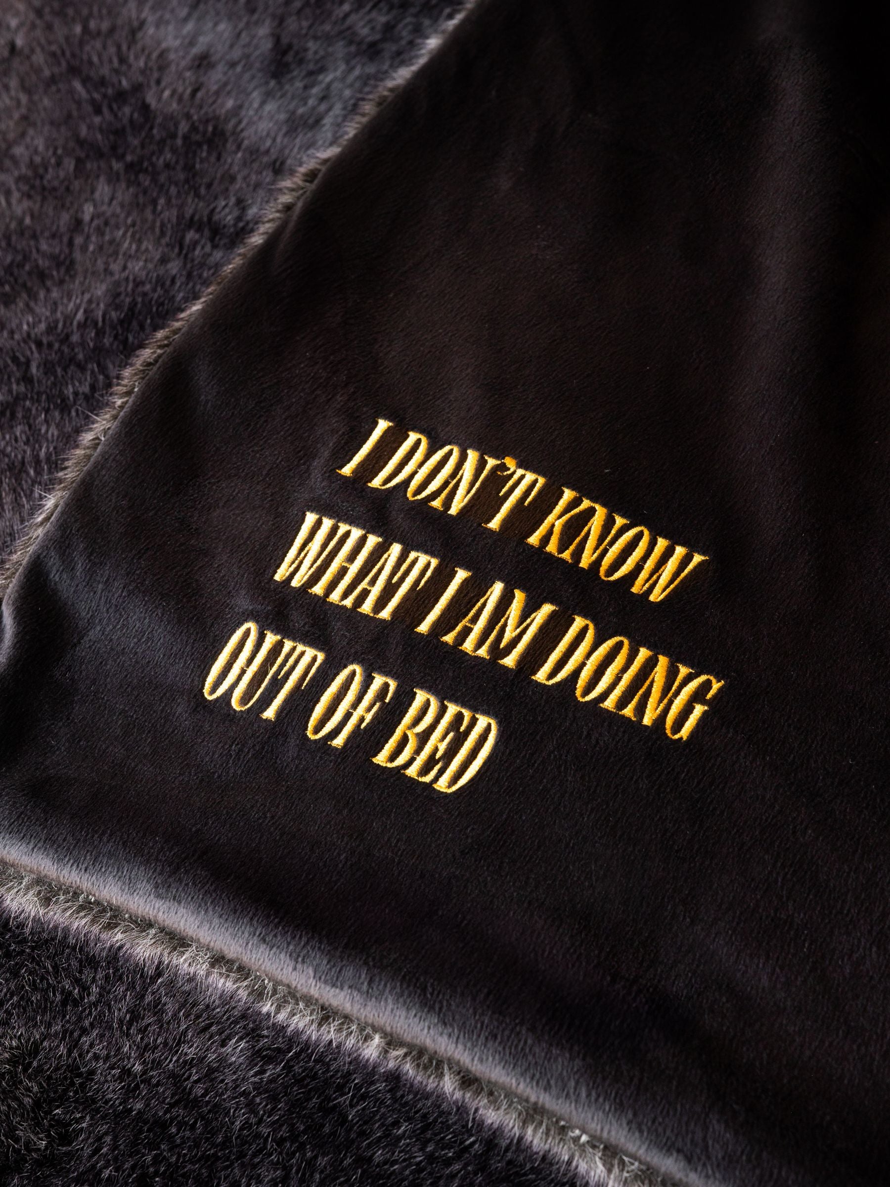 Rockett St George black luxe faux fur slogan throw British brand