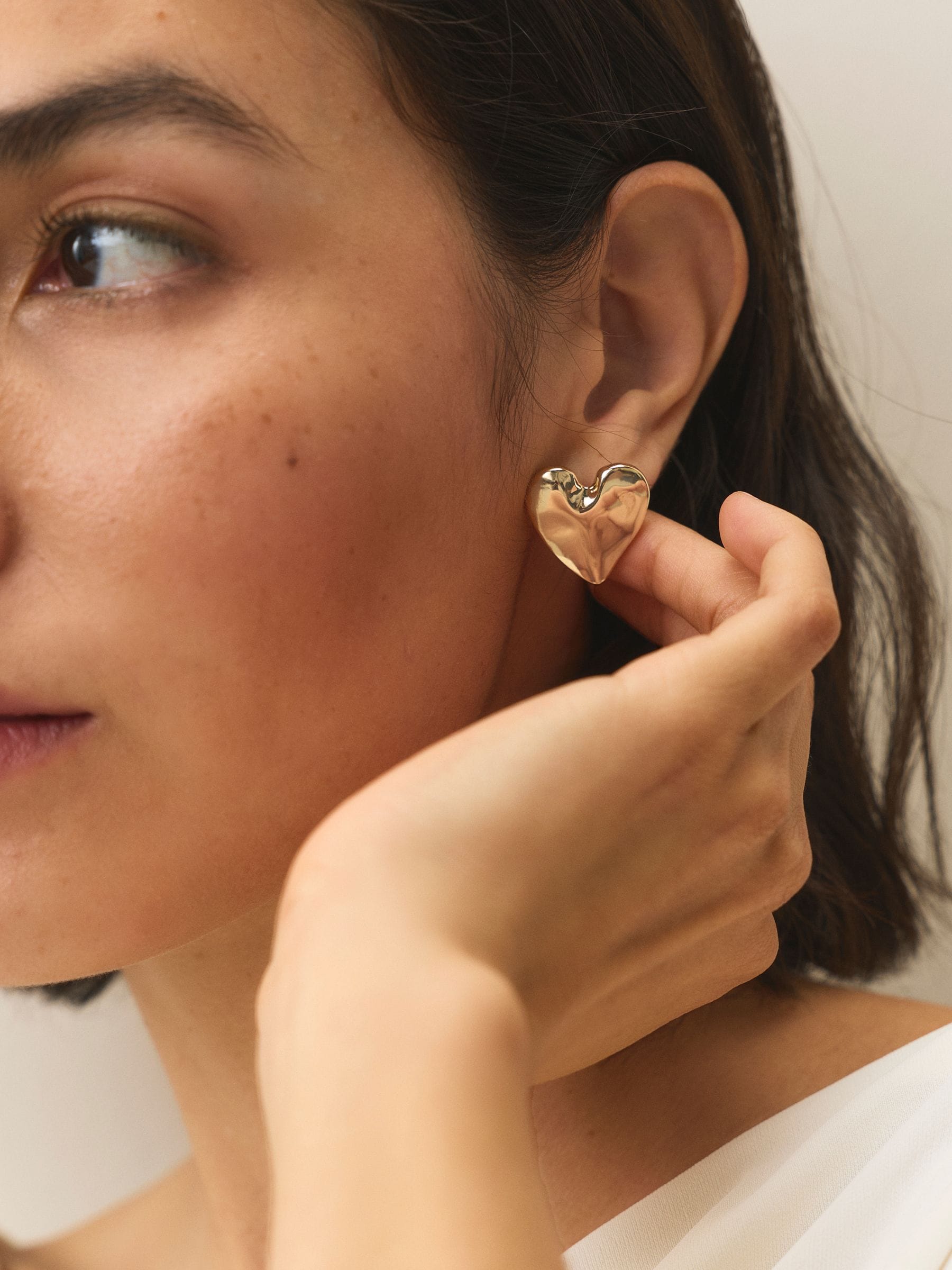 Gold tone heart stud earrings, UK version