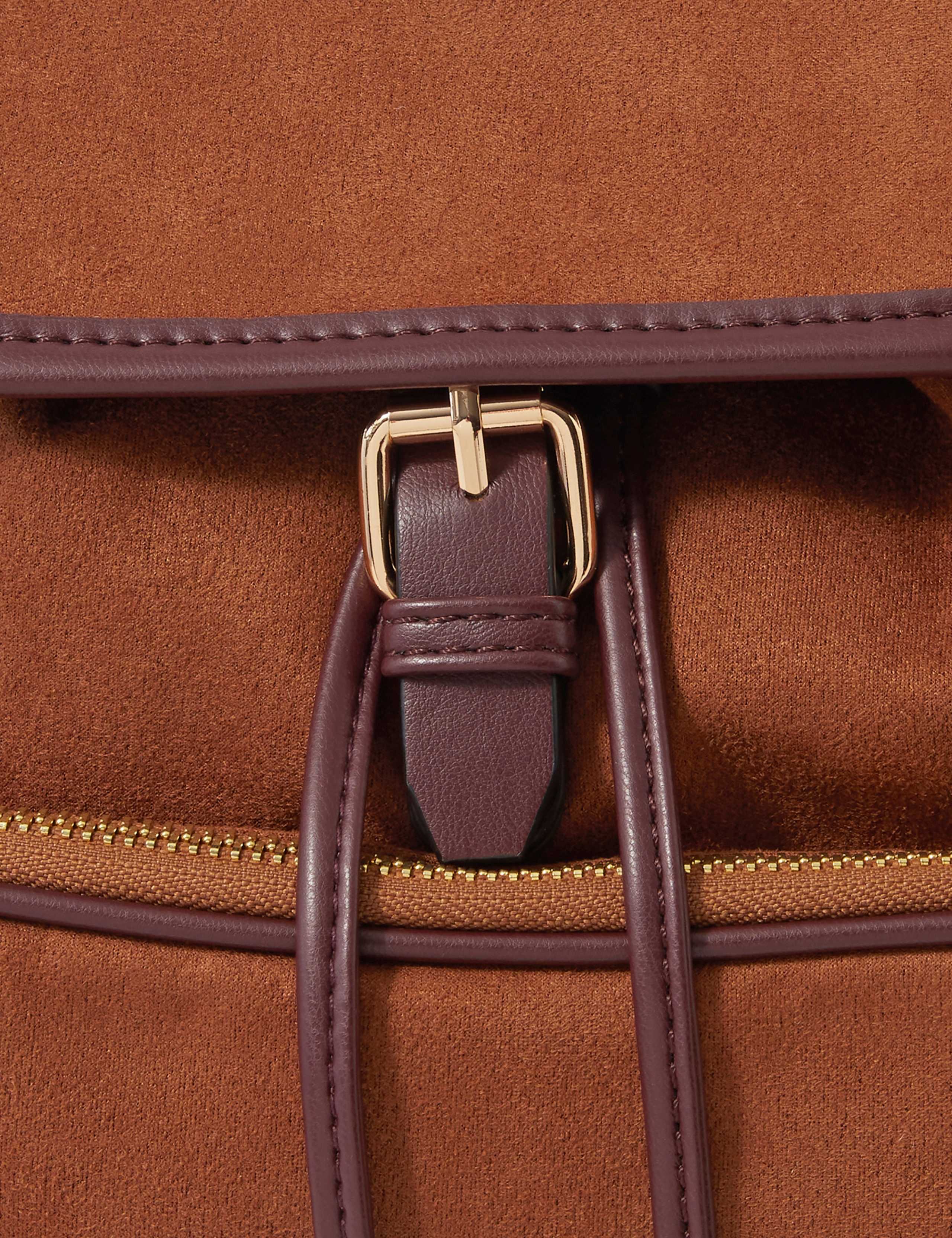 Accessorize faux suede backpack with gold hardware, imported from the UK