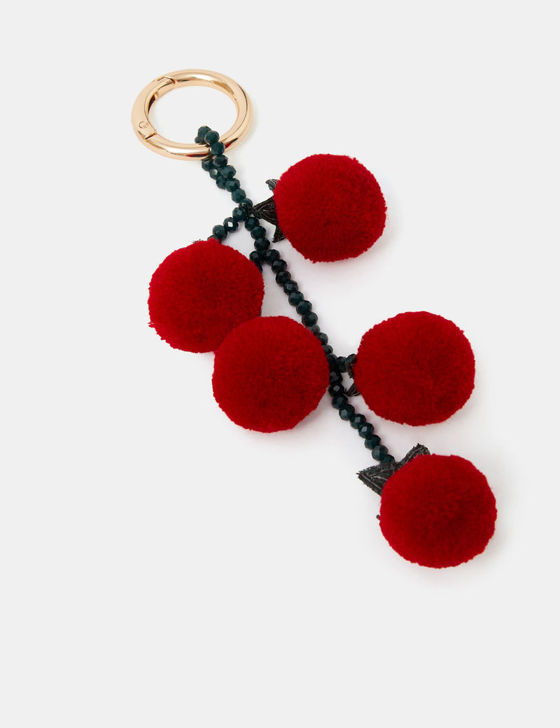 Accessorize fluffy tomato bag charm with pom-pom cherry tomatoes, imported from the UK