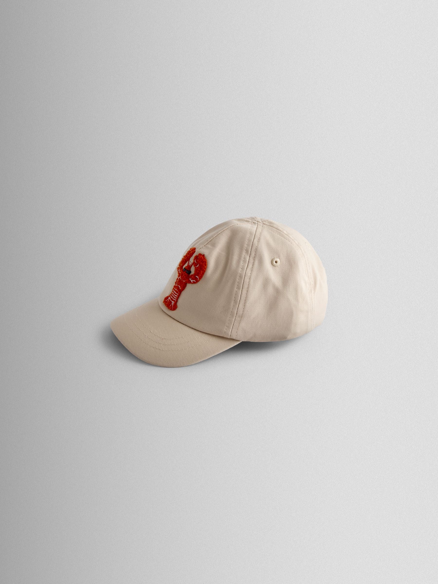 JoJo Maman Bébé ecru lobster bouclé cap, imported from the UK