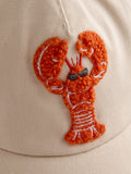 JoJo Maman Bébé ecru lobster bouclé cap, imported from the UK
